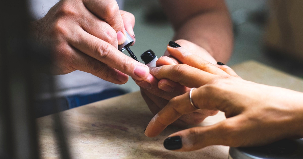 professional woman getting her nails painted