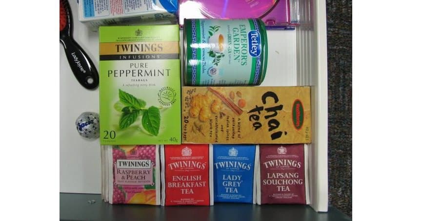 tips on dining and snacking at the office - image of a desk drawer tea stash