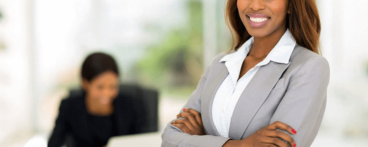 professional young black woman wearing a suit and collared shirt (her collar is outside the blazer)