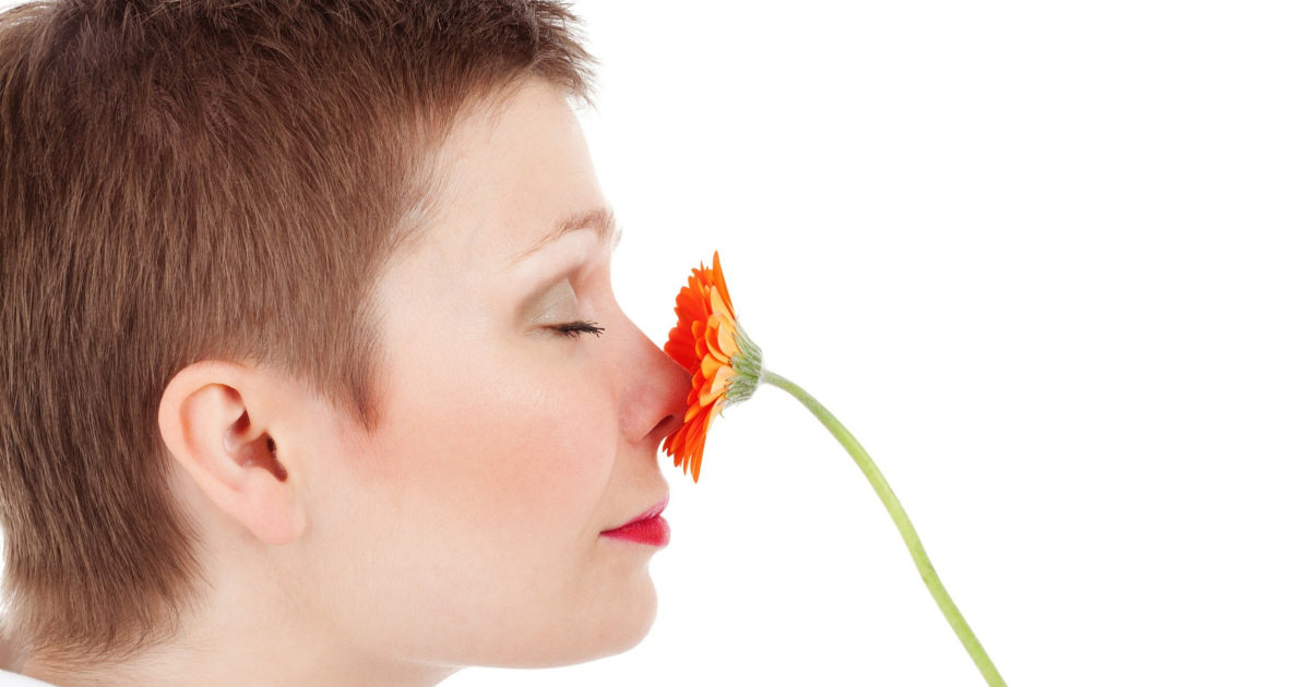 stock photo of a woman smelling a flower