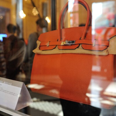 orange Hermes Birkin bag displayed in shop window