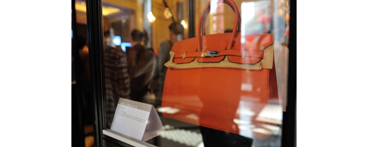 orange Hermes Birkin bag displayed in shop window