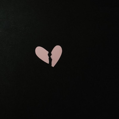 broken heart in pink against a black background