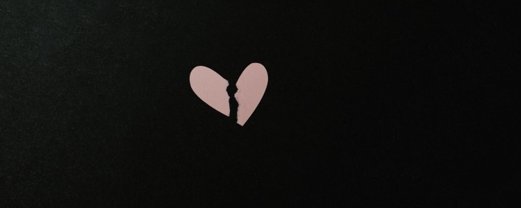 broken heart in pink against a black background