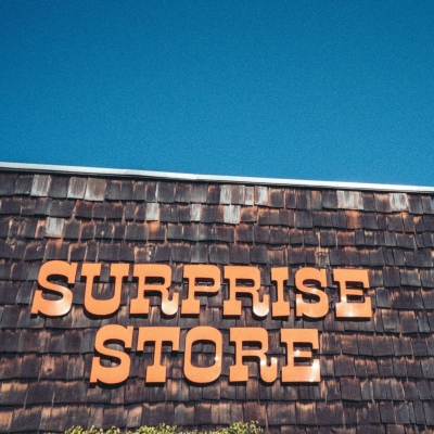 store sign reads "Surprise Store" in orangef