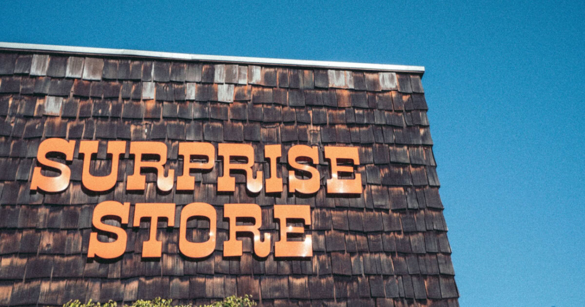 store sign reads "Surprise Store" in orange