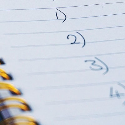 handwritten list in notebook reads 1), 2), 3), 4)