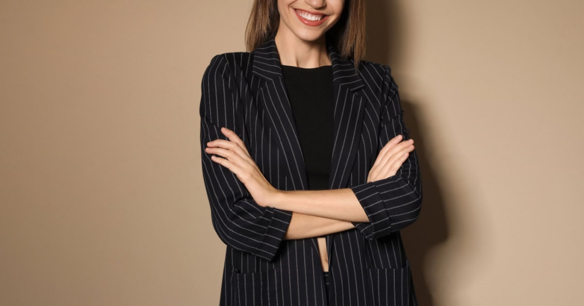 store model wearing a three-quarter sleeved blazer confident young businesswoman wears a pinstriped blazer with three-quarter sleeves