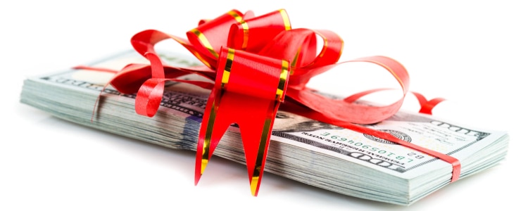 a pile of cash has a red ribbon around it, tied in a big bow