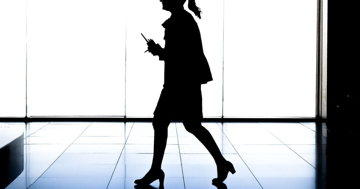 stock photo of professional woman walking in shadow