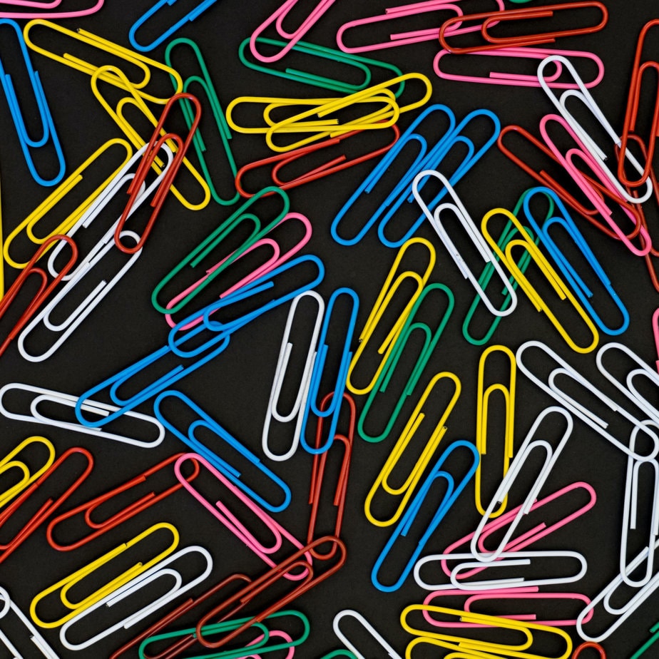 paperclips against a black background