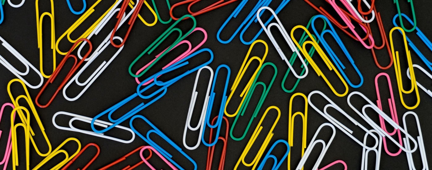 paperclips against a black background