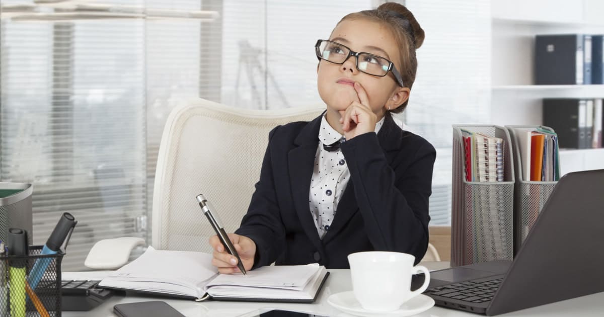 how to be taken seriously when you look young - image of a young girl dressed like a business woman