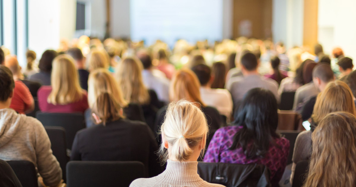 stock photo of professional woman sitting in conference audience