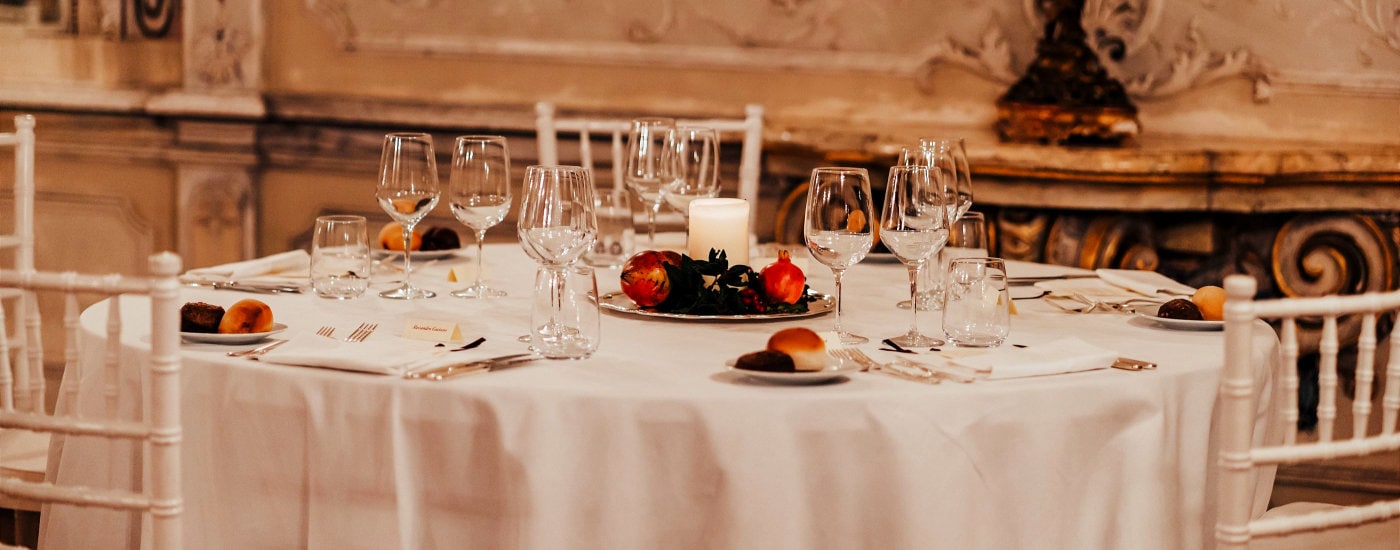 table set beautifully with tablecloth, rolls, and more