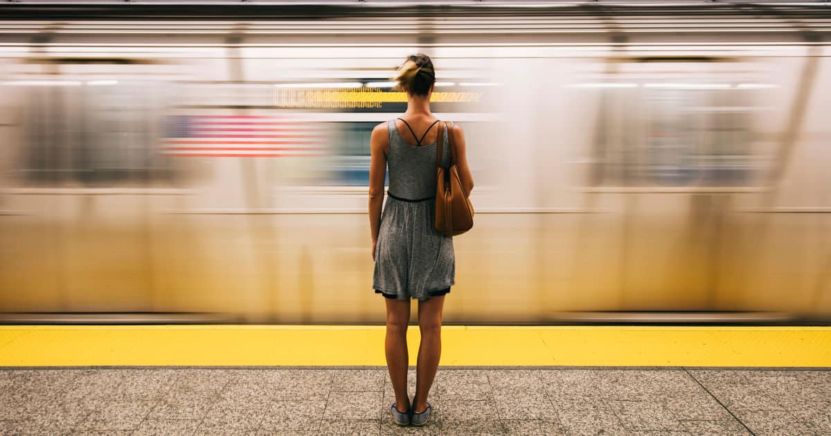 how to stay cool on your commute - image of a stylish young professional waiting for her subway