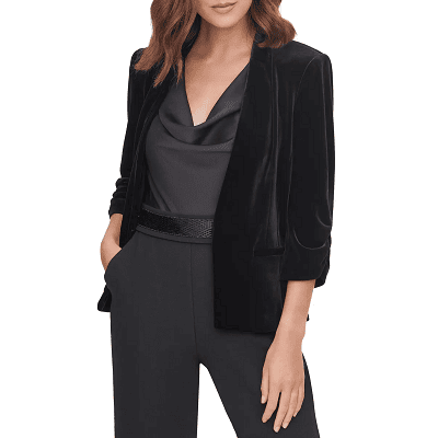 woman wears black velvet blazer with all-black outfit; there are numerous textures in her outfit