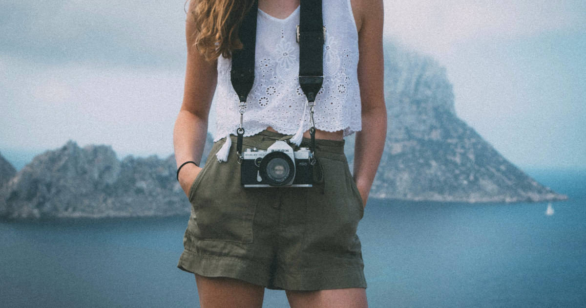 how to wear shorts as an adult woman | picture of stylish shorts and top combo on vacationing woman