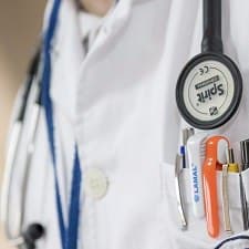 close-up of doctor's torso with a stethoscope and pocket full of tools