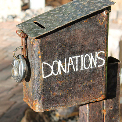 rust-covered box that reads DONATIONS