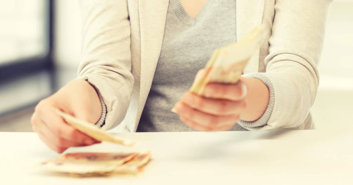 do you have to give your salary history? image of a woman counting money