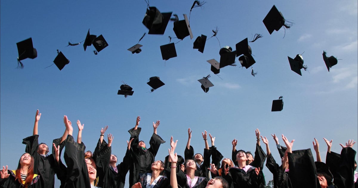 what to wear to law school graduation - image of women law students throwing caps in the air