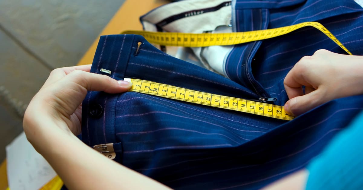 the best made-to-order clothing for professional women - image of a woman measuring a bespoke, custom pair of pants made to order