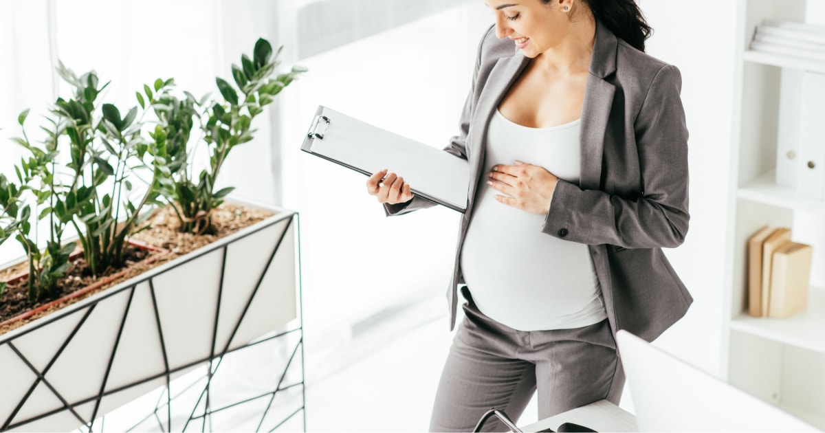 professional pregnant woman wearing an interview suit