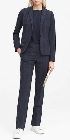 woman wears navy check suit with sneakers