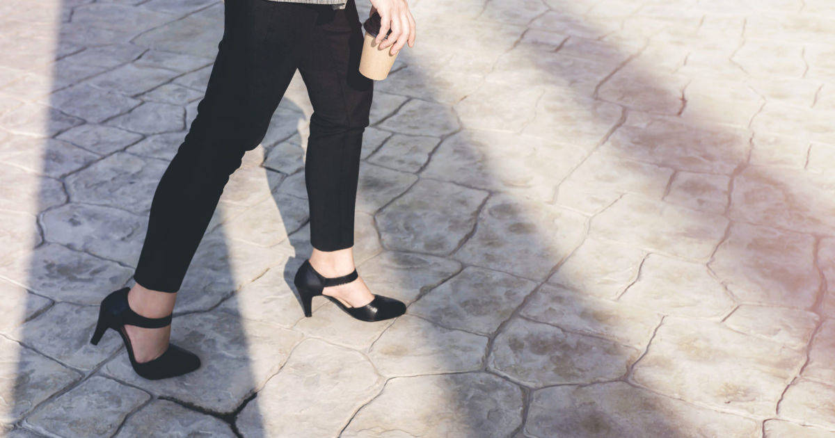 woman walking on cobblestone