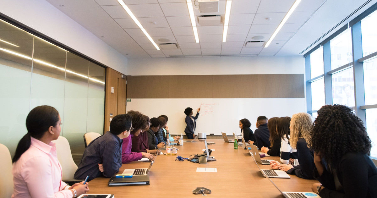 image of woman leading a continuing education class in an office conference room