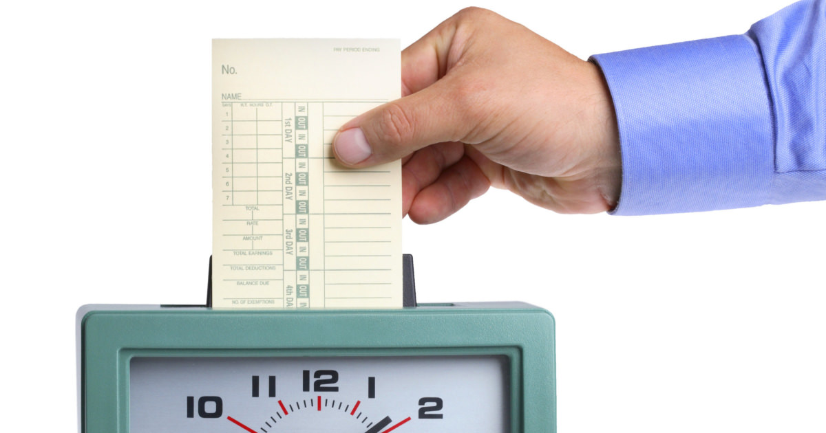 stock photo of a punch clock with a man holding a time card