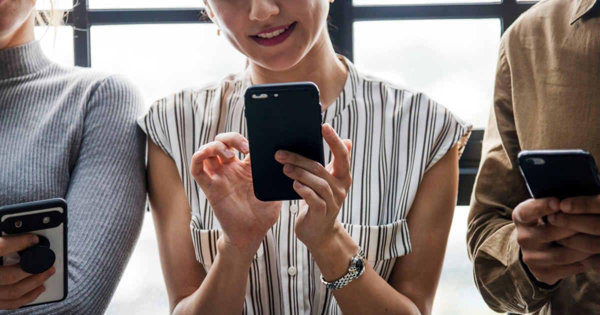stock photo of young professional woman using an app on her phone