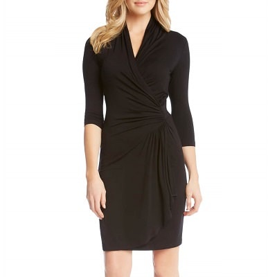 black stretchy dress with V-neck and cascading ruffle-ish detail that begins at waist and goes down side of skirt