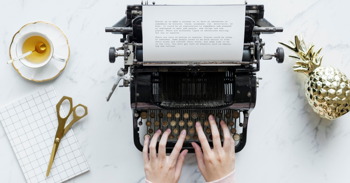 professional woman typing on old-fashioned typewriter