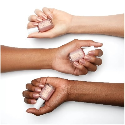 three women of different skin tones displaying Essie's Touch of Sugar polish 