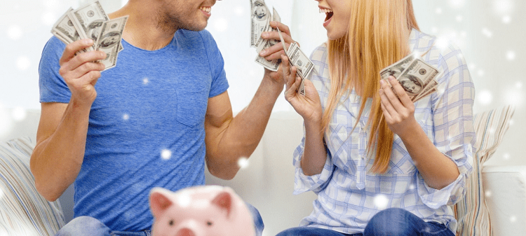 man and woman hold fistfuls of cash and smile at each other; a pink piggybank sits in foreground
