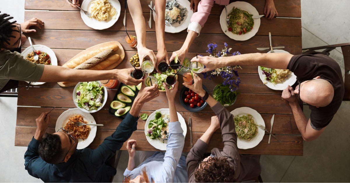 10 people toasting over a shared meal