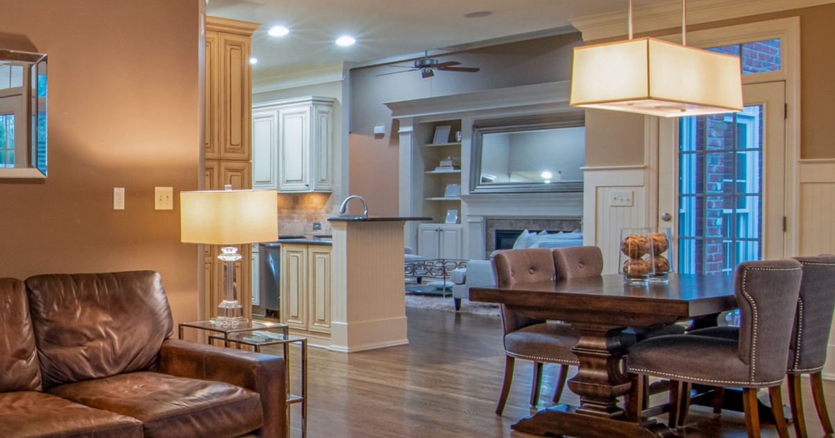 photo of a suburban home with table lights, undercabinet lighting, and a dining table chandelier