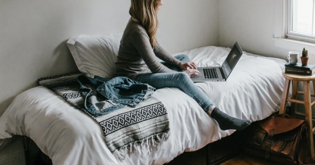 woman working on her bed