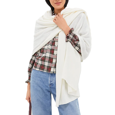 woman wears white office shawl aka blanket scarf; it is thrown over her shoulder in an artful way