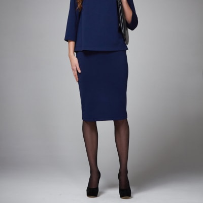 Stock photo of woman wearing black tights with a navy skirt