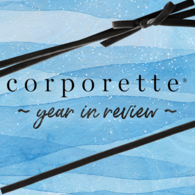 reads graphics "corporate year reviewed" - graphic has black velvet bow detail (like a gift)