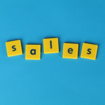 yellow blocks spell the word SALES; they sit on a blue background