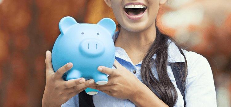 A white woman with long brown hair (face partially cropped out) smiling and holding a blue piggy bank