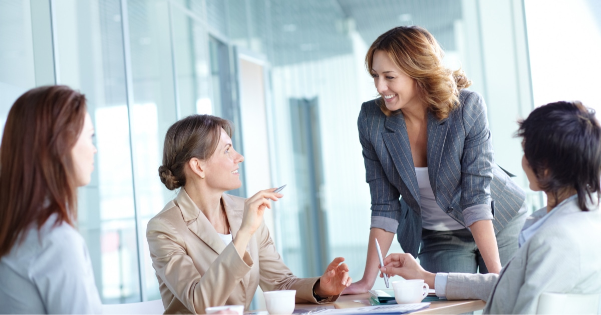 group of professional women smiling and laughing