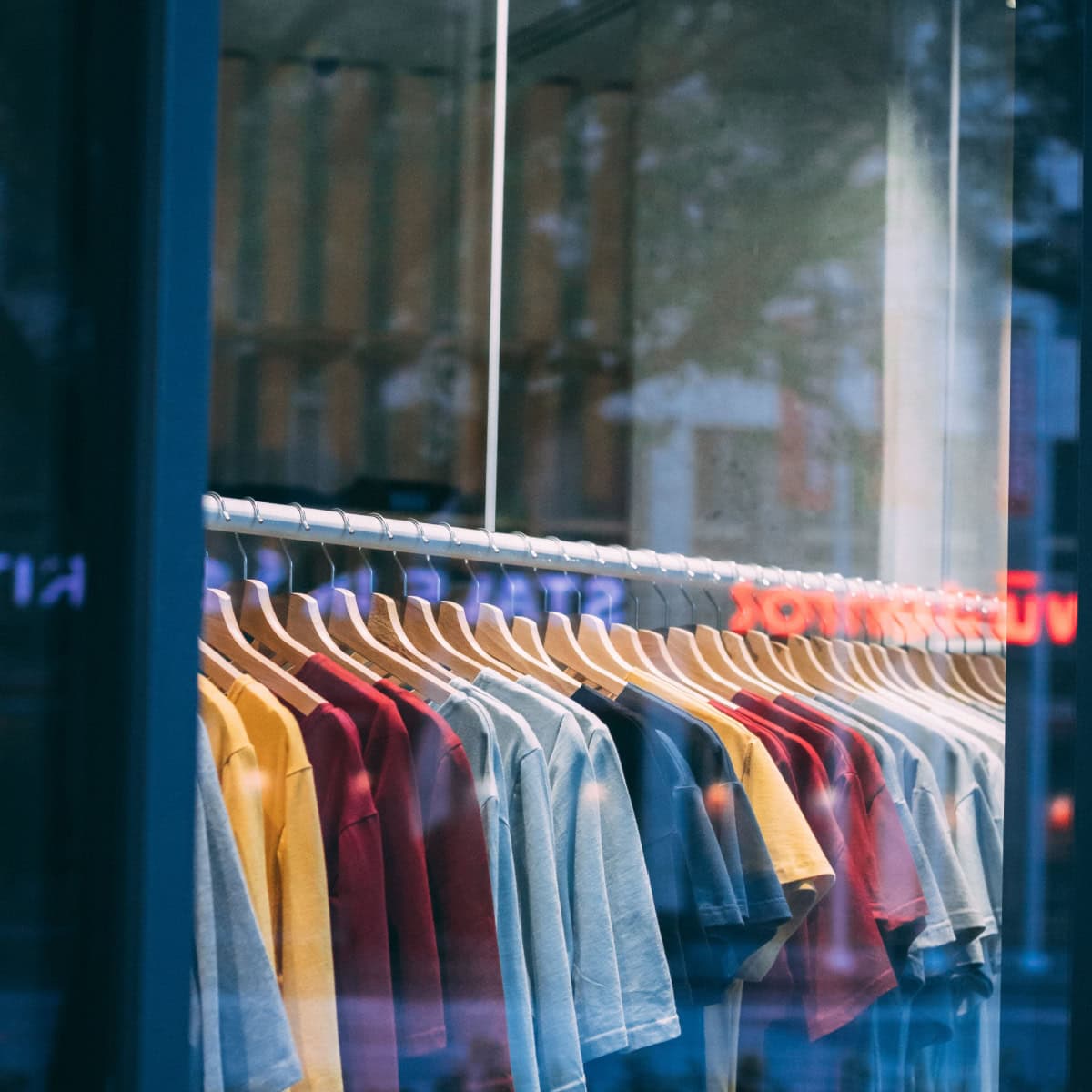 clothing rack in a store, viewed from the sidewalk