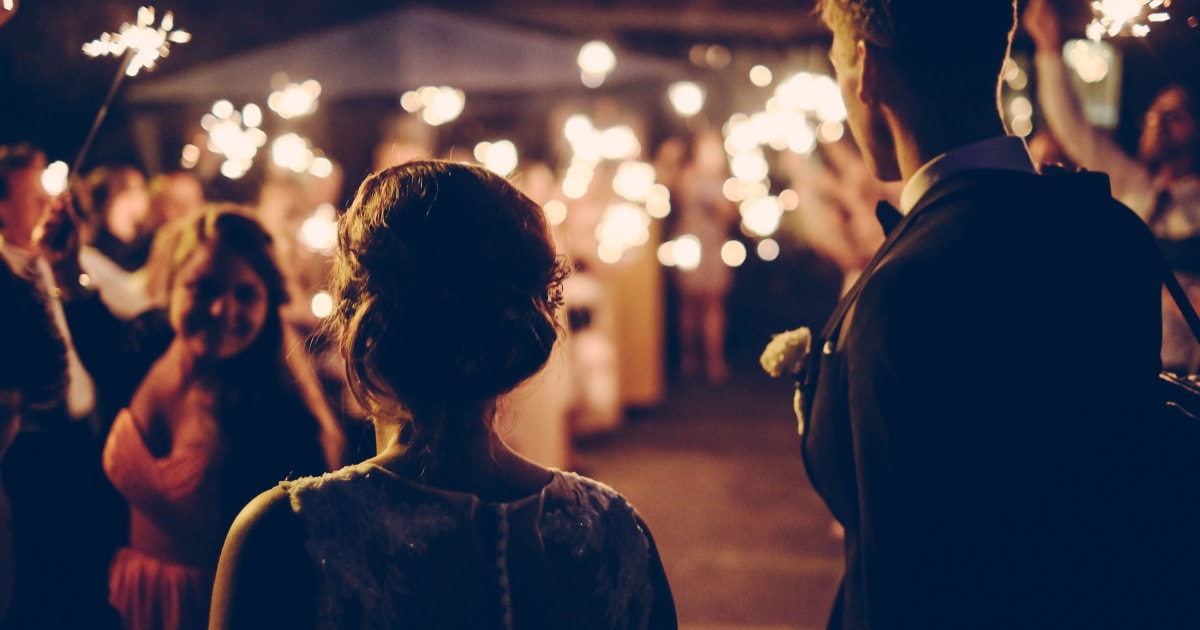 bride and groom enter a wedding reception