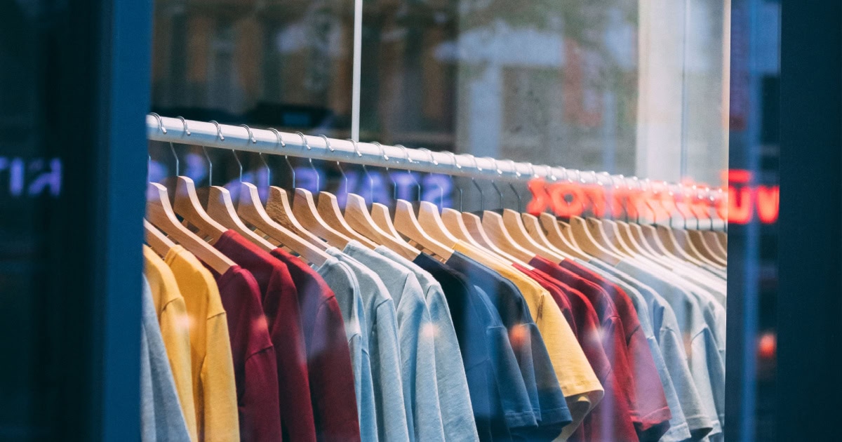 clothing rack in a store, viewed from the sidewalk