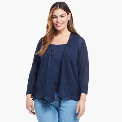 plus size professional woman wears a navy cardigan and blue jeans